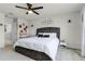 Spacious bedroom featuring a ceiling fan, bedside table, and a vanity area at 5329 Royal Point Ave, Kissimmee, FL 34746