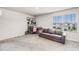 Bedroom with a grey couch, desk, and large window at 5329 Royal Point Ave, Kissimmee, FL 34746