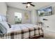 Well-lit bedroom featuring a ceiling fan, wall-mounted television, and a view to the outside at 5329 Royal Point Ave, Kissimmee, FL 34746