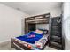 Bedroom with a dark wood bunk bed featuring built in stairs and a fun Spider-Personal theme at 5329 Royal Point Ave, Kissimmee, FL 34746
