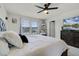 Comfortable bedroom featuring a ceiling fan, bedside table, and a window at 5329 Royal Point Ave, Kissimmee, FL 34746