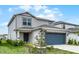 Attractive home featuring a two-car garage and welcoming landscaping, enhancing its street presence at 5329 Royal Point Ave, Kissimmee, FL 34746