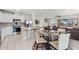 Open eat-in kitchen and living area features stainless appliances, island seating, and a comfortable living area at 5329 Royal Point Ave, Kissimmee, FL 34746