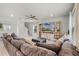 Comfortable living room area with a large sectional couch, entertainment center, and ceiling fan at 5329 Royal Point Ave, Kissimmee, FL 34746