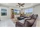Bright living room with a large window, ceiling fan, and entertainment center, perfect for relaxation at 5329 Royal Point Ave, Kissimmee, FL 34746