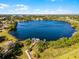 Breathtaking aerial view of a vast lake surrounded by lush greenery and waterfront docks at 5402 Kingswood Dr, Orlando, FL 32810