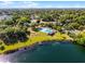 Aerial view of neighborhood amenities, featuring a community pool, lake access, and lush green surroundings at 5402 Kingswood Dr, Orlando, FL 32810