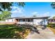 Inviting single-story home featuring an attached garage, covered front porch, and lush lawn at 5402 Kingswood Dr, Orlando, FL 32810