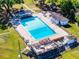 Aerial view of a beautiful pool and sun deck with lounge chairs and picnic tables around the property at 5402 Kingswood Dr, Orlando, FL 32810