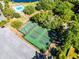 Aerial view of community basketball and pickleball courts, surrounded by trees and green spaces at 5402 Kingswood Dr, Orlando, FL 32810