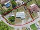 Expansive aerial view of a home with a large yard, featuring a circular driveway and ample parking at 549 Mcneal Dr, Deltona, FL 32725