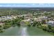 Picturesque aerial view capturing a residential area adjacent to a lake surrounded by mature trees and lush greenery at 549 Mcneal Dr, Deltona, FL 32725