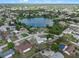 Extensive aerial view capturing a neighborhood near a beautiful blue lake, showcasing numerous homes and green spaces at 549 Mcneal Dr, Deltona, FL 32725