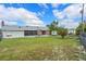 Expansive backyard with a mix of green lawn, with a screened-in patio at 549 Mcneal Dr, Deltona, FL 32725