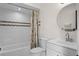 Bathroom featuring a tiled shower-tub combo, white vanity, and modern fixtures providing a clean and functional space at 549 Mcneal Dr, Deltona, FL 32725
