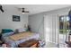 Bright bedroom with sliding glass doors and a ceiling fan offering natural light and comfortable living at 549 Mcneal Dr, Deltona, FL 32725