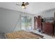 Bedroom with sliding glass doors with a ceiling fan offering natural light and comfortable living at 549 Mcneal Dr, Deltona, FL 32725
