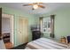 Bedroom with a ceiling fan and large window offers a comfortable and inviting space with ample natural light at 549 Mcneal Dr, Deltona, FL 32725