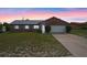 Charming brick home featuring a well-maintained lawn and attached two-car garage at 549 Mcneal Dr, Deltona, FL 32725