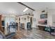 Open-concept living room with wood floors, skylight and adjacent dining area creating a warm and inviting space at 549 Mcneal Dr, Deltona, FL 32725