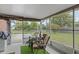 Outdoor patio area with seating, a table, plants and natural views at 549 Mcneal Dr, Deltona, FL 32725