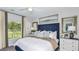Cozy bedroom with plush bedding, decorative pillows, a ceiling fan and a view of the outdoors at 5663 Loggia Ln, Kissimmee, FL 34758
