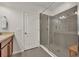 Walk-in shower with gray tile surround, glass door and built-in bench at 58 Zamora Pl, Oviedo, FL 32765