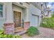 Close-up of a cozy front porch with brick accents and stylish decor at 58 Zamora Pl, Oviedo, FL 32765