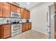 Functional kitchen featuring stainless steel appliances and ample cabinet space at 58 Zamora Pl, Oviedo, FL 32765