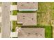 Aerial view of rooftops with lush landscaping and community street at 715 Chinoy Rd, Davenport, FL 33837