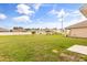 Expansive backyard featuring a lush green lawn and a full fence for privacy at 715 Chinoy Rd, Davenport, FL 33837