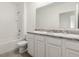 Bright bathroom featuring double vanity with granite countertop and tiled floors at 715 Chinoy Rd, Davenport, FL 33837