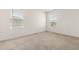 Bright and airy bedroom featuring neutral carpet, white walls, and natural light from two windows at 715 Chinoy Rd, Davenport, FL 33837