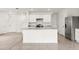 Open-concept kitchen with a central island, stainless steel appliances, white cabinets, and tile flooring at 715 Chinoy Rd, Davenport, FL 33837