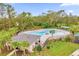 Community pool area with ample seating, a splash pad, and verdant landscaping at 715 Chinoy Rd, Davenport, FL 33837