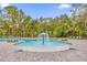 Community pool features a splash pad, lounge chairs, shade and verdant landscaping at 715 Chinoy Rd, Davenport, FL 33837