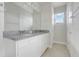 Bathroom with double sink vanity, granite countertop, and a large mirror at 7772 Sweet Star Avenue, Orlando, FL 32836