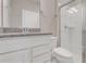 Bathroom featuring granite counters, a white vanity, and a glass-enclosed shower at 7772 Sweet Star Avenue, Orlando, FL 32836