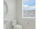Half bathroom features a modern sink and toilet, complete with a window and natural light at 7772 Sweet Star Avenue, Orlando, FL 32836