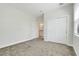 Neutral bedroom featuring carpet floors, closet, and a doorway to an ensuite bathroom at 7772 Sweet Star Avenue, Orlando, FL 32836