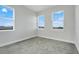 Bright bedroom with carpet, three large windows offering views and natural light at 7772 Sweet Star Avenue, Orlando, FL 32836
