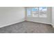 Bright bedroom with carpet, featuring three windows offering natural light and views at 7772 Sweet Star Avenue, Orlando, FL 32836