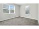 Bright bedroom with carpet floor, two large windows with blinds and neutral walls at 7772 Sweet Star Avenue, Orlando, FL 32836