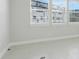 Empty room with light tile floor, white walls, and large window with blinds at 7772 Sweet Star Avenue, Orlando, FL 32836