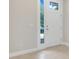 Bright entryway featuring neutral walls, a modern front door, and durable tile flooring at 7772 Sweet Star Avenue, Orlando, FL 32836