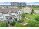 Three-story townhome, with covered balconies, surrounded by lush greenery at 7772 Sweet Star Avenue, Orlando, FL 32836