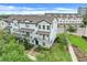 Beautiful exterior of a three-story townhome with lush landscaping and great curb appeal at 7772 Sweet Star Avenue, Orlando, FL 32836