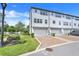 View of the back of the townhouses, featuring two car garages and landscaped walkways and gardens at 7772 Sweet Star Avenue, Orlando, FL 32836