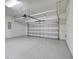 Large two car garage with epoxy flooring, white block walls, and overhead storage at 7772 Sweet Star Avenue, Orlando, FL 32836