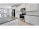 Bright kitchen with white cabinets, granite countertops, and stainless steel appliances at 7772 Sweet Star Avenue, Orlando, FL 32836